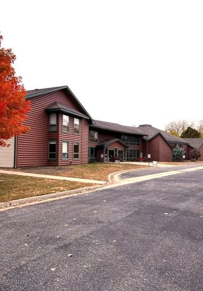 Two chairs on a dock overlooking a pond