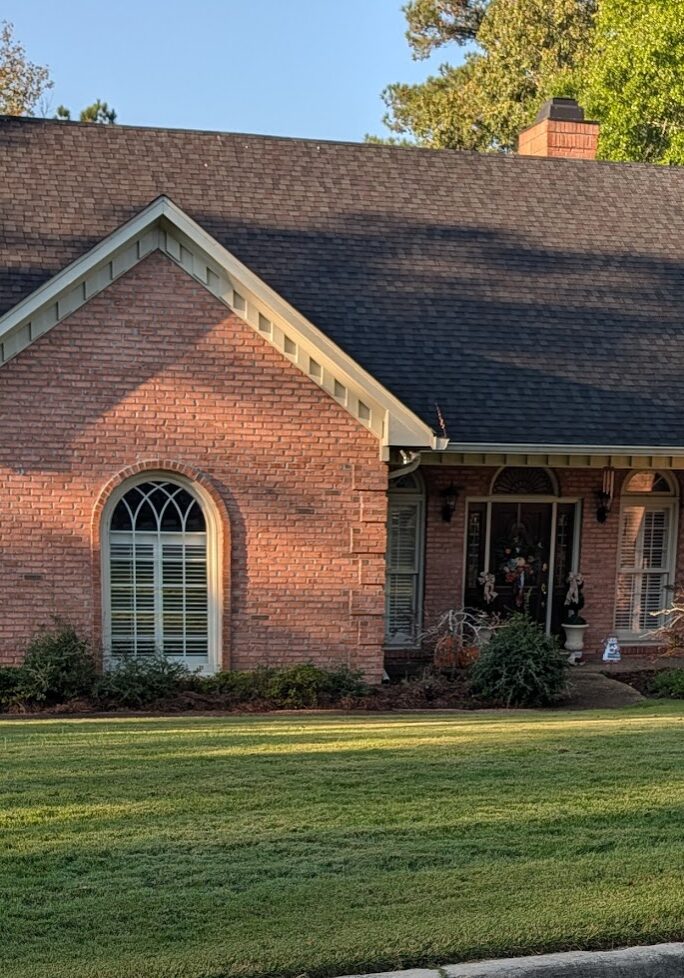 Two chairs on a dock overlooking a pond